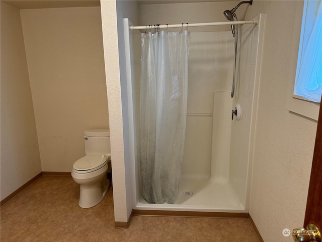 bathroom with toilet and walk in shower