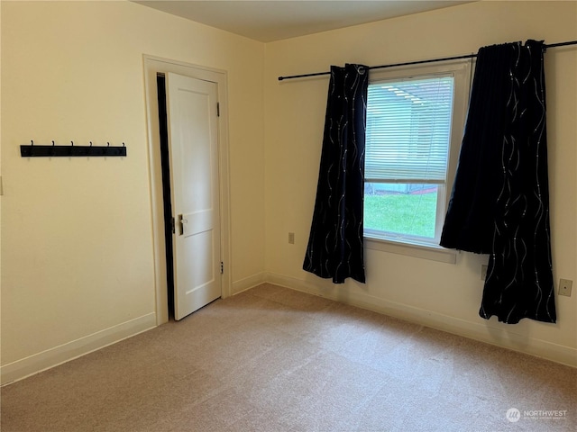 carpeted empty room with a healthy amount of sunlight