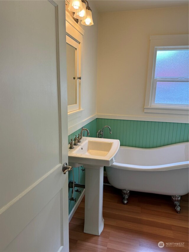 bathroom featuring hardwood / wood-style floors and a tub