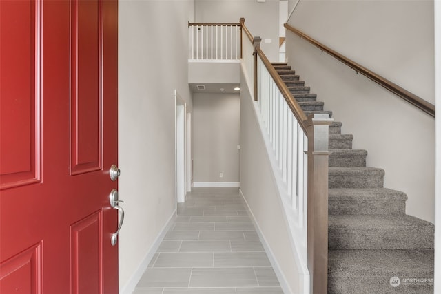 foyer entrance featuring a towering ceiling