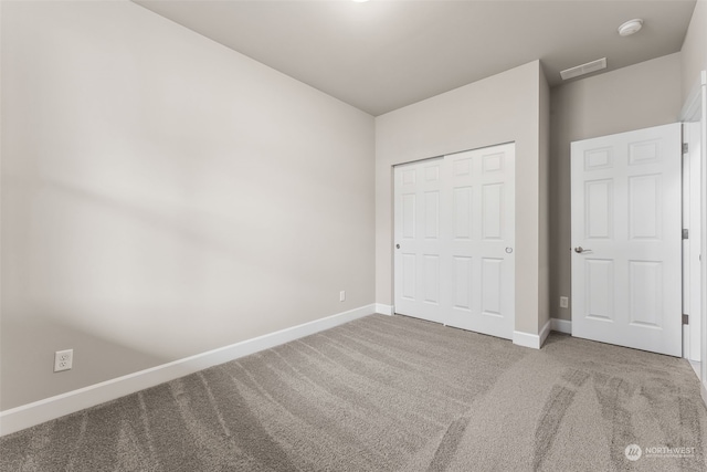 unfurnished bedroom with a closet and carpet