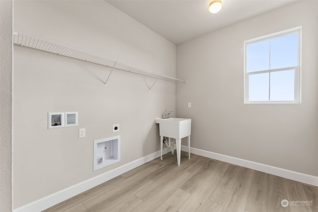 laundry room featuring washer hookup, hookup for an electric dryer, and light hardwood / wood-style flooring