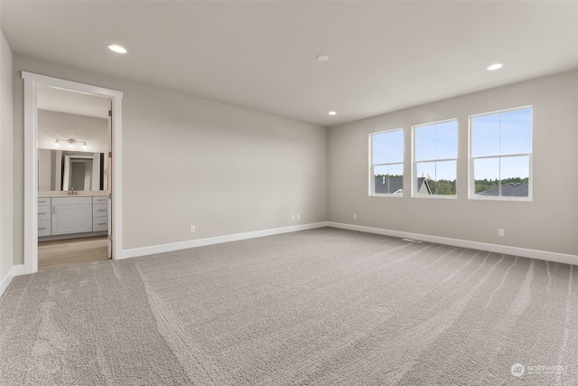 carpeted spare room with sink