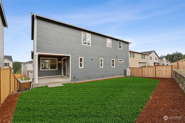 rear view of property with a patio and a yard