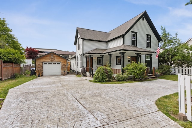 view of front of house with a garage, an outdoor structure, and covered porch