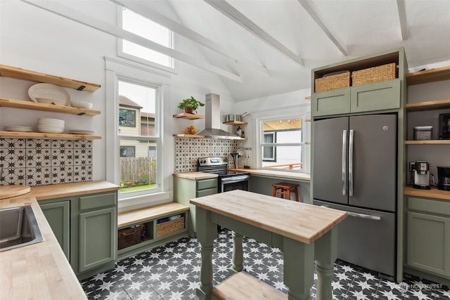 kitchen with butcher block countertops, green cabinets, island range hood, and appliances with stainless steel finishes