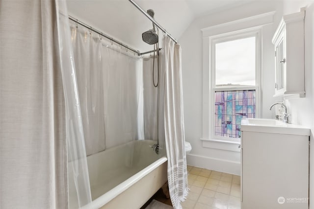 full bathroom featuring vanity, vaulted ceiling, shower / bath combo with shower curtain, and a wealth of natural light