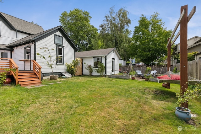 view of yard featuring a wooden deck and an outdoor structure