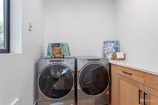 laundry area with cabinets and washing machine and dryer