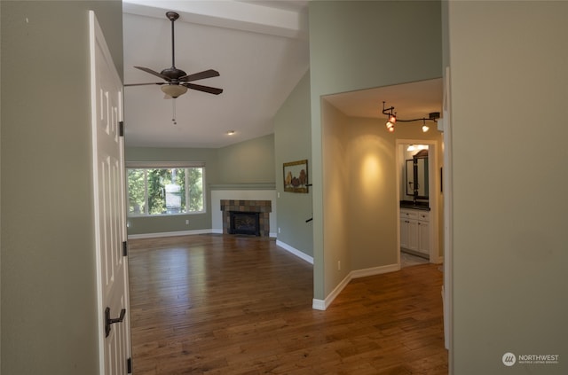 unfurnished living room with high vaulted ceiling, a fireplace, wood-type flooring, and ceiling fan