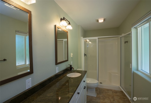 bathroom featuring an enclosed shower, tile flooring, toilet, and oversized vanity