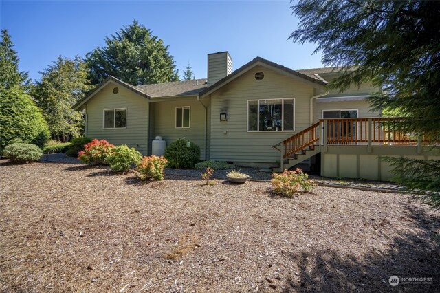 ranch-style home featuring a wooden deck