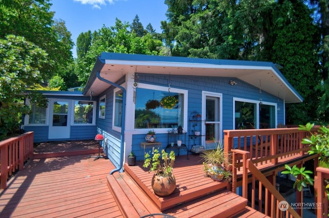 wooden deck featuring a sunroom