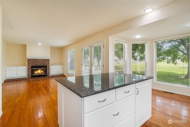 kitchen featuring white cabinets and a wealth of natural light