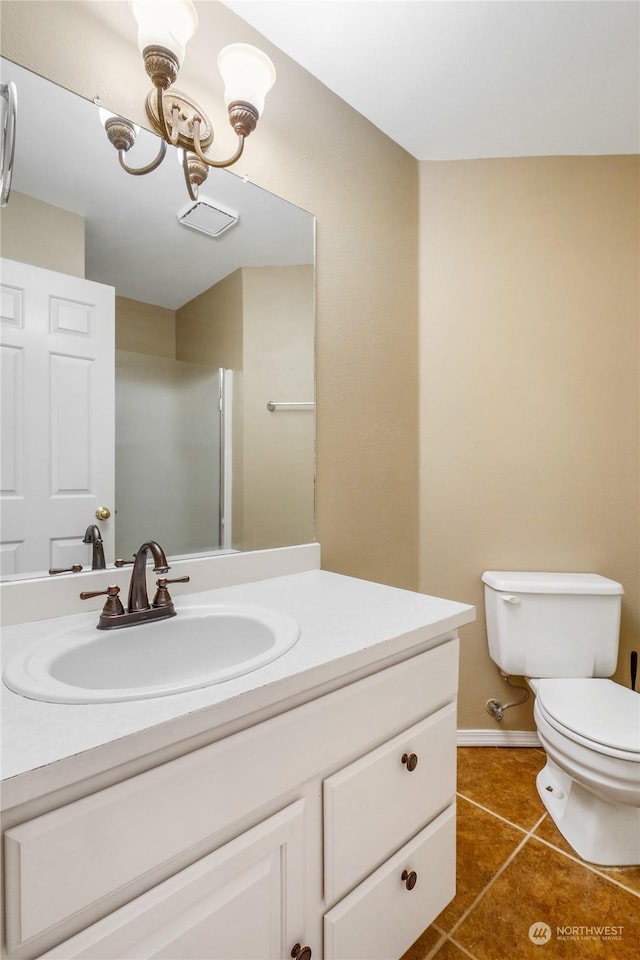 bathroom featuring toilet, vanity, and tile patterned floors