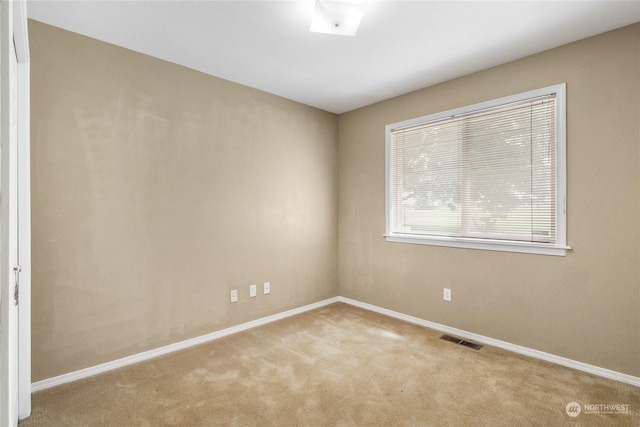 unfurnished room with light colored carpet