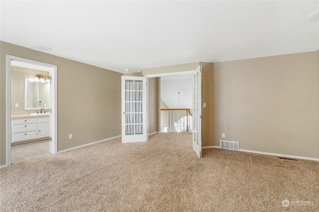 carpeted spare room with sink