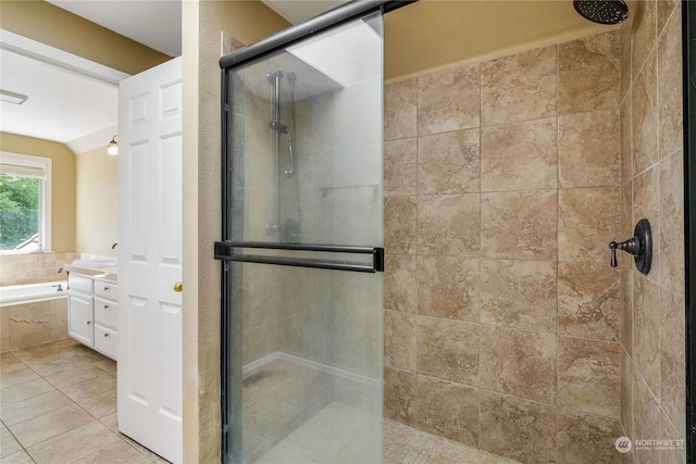 bathroom with tile patterned floors and separate shower and tub