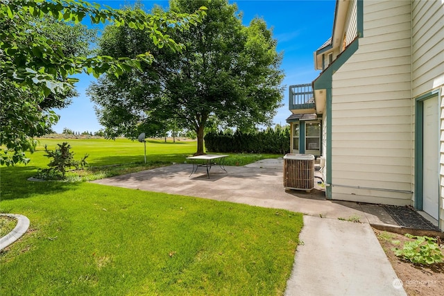 view of yard featuring cooling unit and a patio