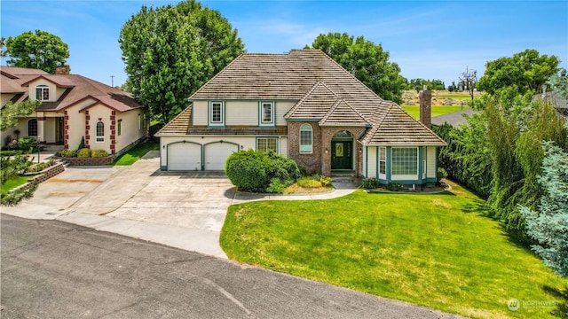 view of front of house with a front yard and a garage