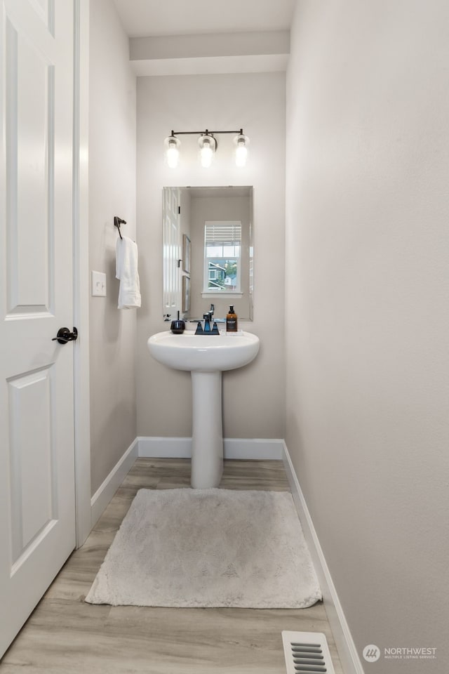 bathroom with hardwood / wood-style flooring