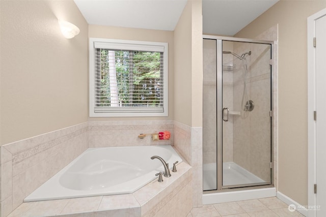 bathroom featuring plus walk in shower and tile patterned floors