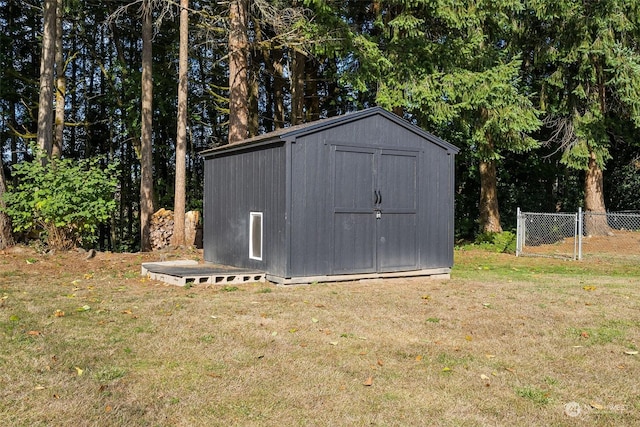 view of outbuilding featuring a lawn