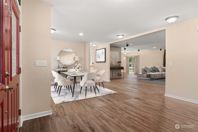 dining space with hardwood / wood-style floors and ceiling fan