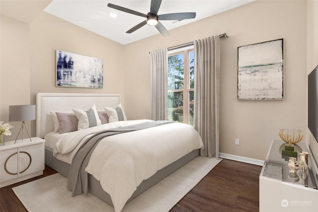 bedroom with ceiling fan and dark hardwood / wood-style flooring