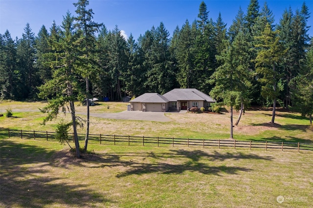 view of yard featuring a rural view and a garage