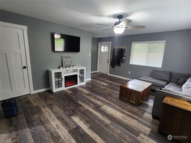 living room featuring dark hardwood / wood-style flooring and ceiling fan