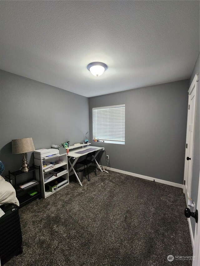 bedroom featuring baseboards, carpet floors, and a textured ceiling