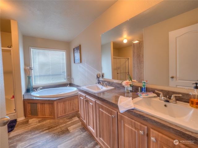 bathroom with shower with separate bathtub, dual bowl vanity, and hardwood / wood-style flooring