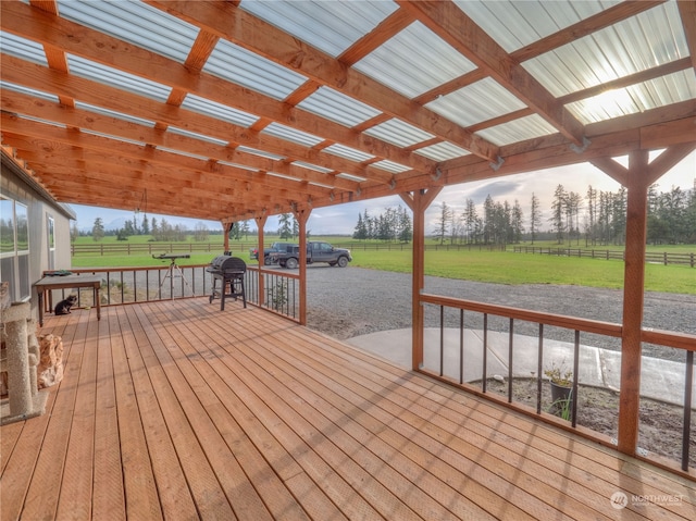 wooden deck featuring a lawn