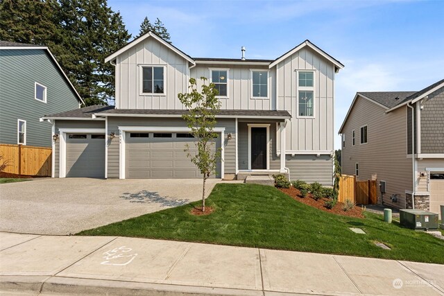 view of front of house with a garage and a front yard