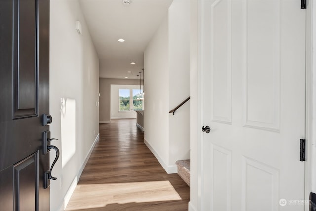 hallway featuring recessed lighting, baseboards, and wood finished floors