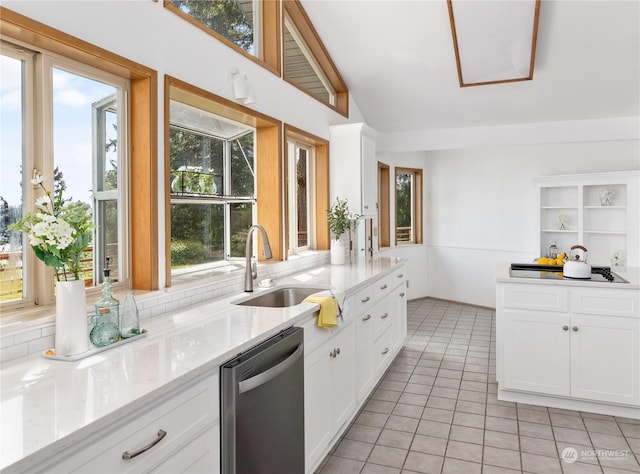 8167 Possession Ridge Ln, Clinton, WA 98236 - kitchen with white cabinetry, sink, light stone counters, and dishwasher