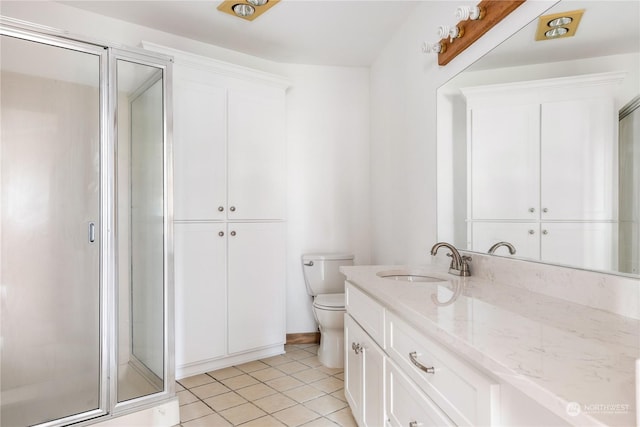 8167 Possession Ridge Ln, Clinton, WA 98236 - bathroom featuring vanity, a shower with shower door, tile patterned floors, and toilet