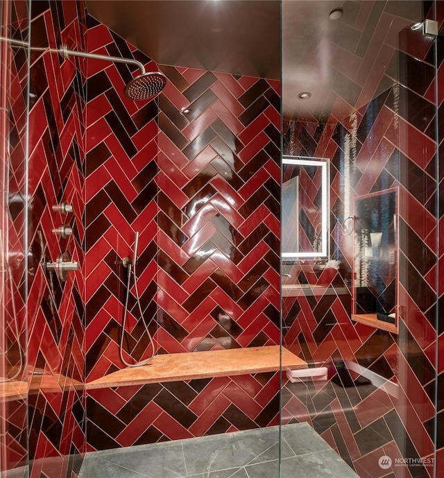 bathroom featuring tile patterned floors and tiled shower