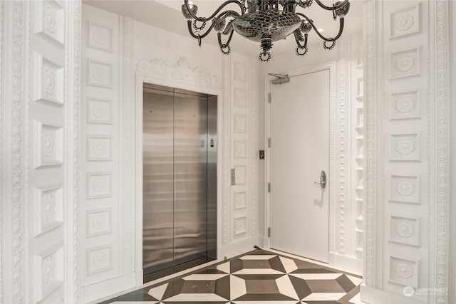 bathroom featuring elevator and a chandelier