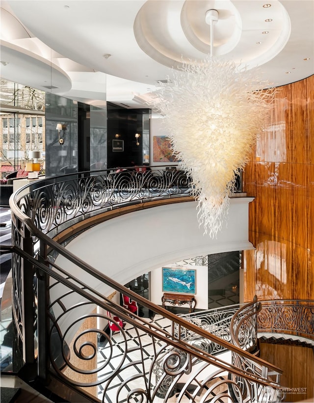 stairs featuring a raised ceiling