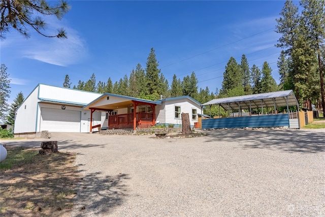 view of front of house with covered porch, a garage, and a carport