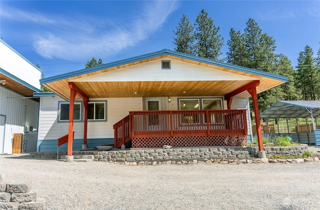 view of front of property with covered porch and a carport