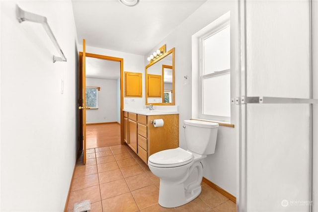 bathroom featuring toilet, vanity, and tile patterned floors