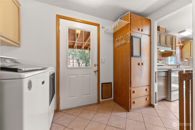 laundry room with cabinets, light tile patterned floors, and washer / clothes dryer