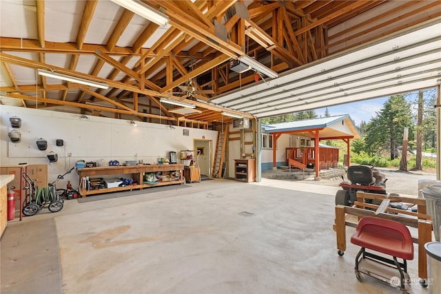 garage with a workshop area and a garage door opener