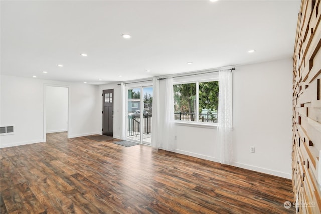 spare room featuring dark hardwood / wood-style flooring