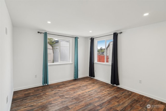 spare room featuring dark hardwood / wood-style flooring