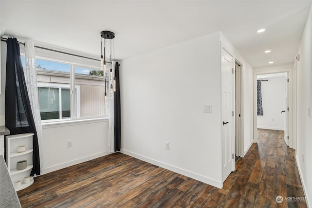 unfurnished room featuring dark wood-type flooring