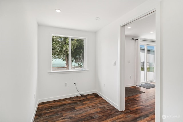 spare room with dark hardwood / wood-style floors